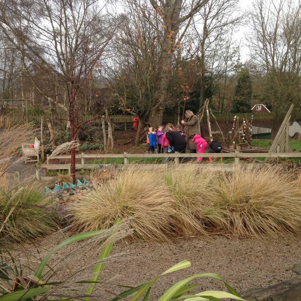 Infant school children working in the school garden